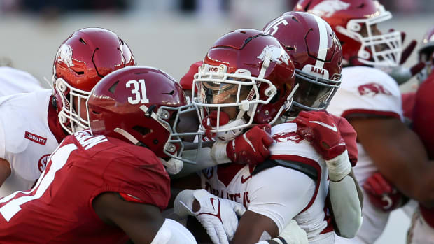 Arkansas running back Trelon Smith (22) is sandwiched by Alabama linebacker Will Anderson Jr. (31) and Alabama linebacker Dallas Turner (15) at Bryant-Denny Stadium.